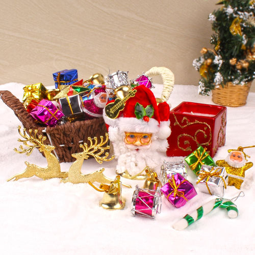 BASKET OF CHRISTMAS TREE ORNAMENTS WITH CANDLE